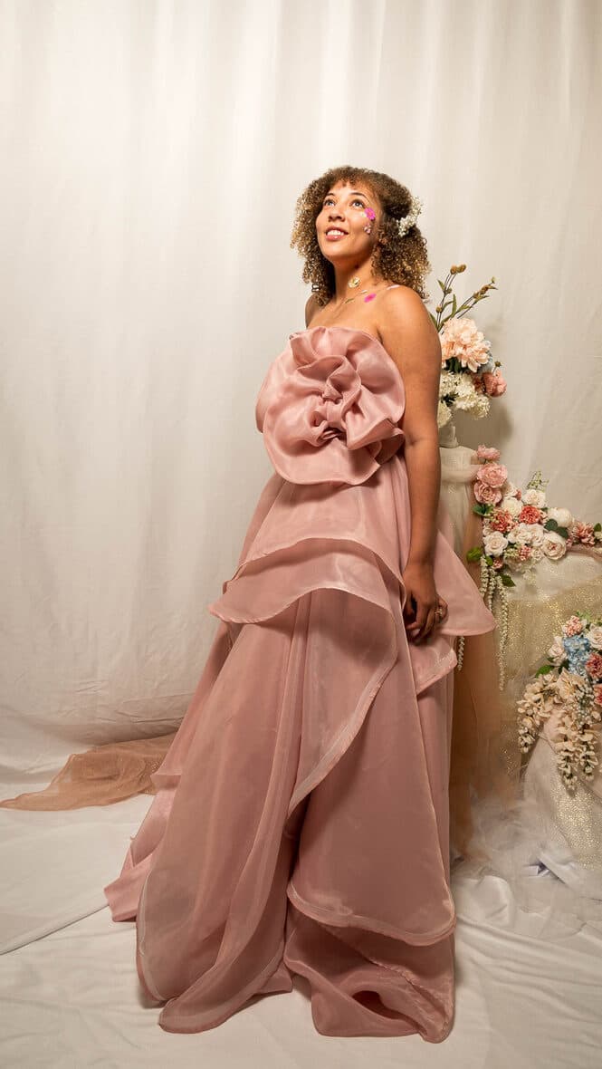 Dusty rose organza gown with an oversized fabric rosette and a tiered ruffled skirt